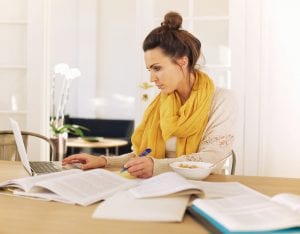 Woman Reviewing Papers and using a Computer