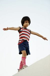 Child balancing on ledge