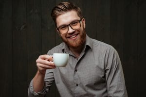 Man Looking Content Holding a Cup of Coffee